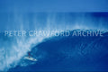 Derek Ho surfing at Pipeline during the Pipe Masters era, photographed by Peter Crawford.