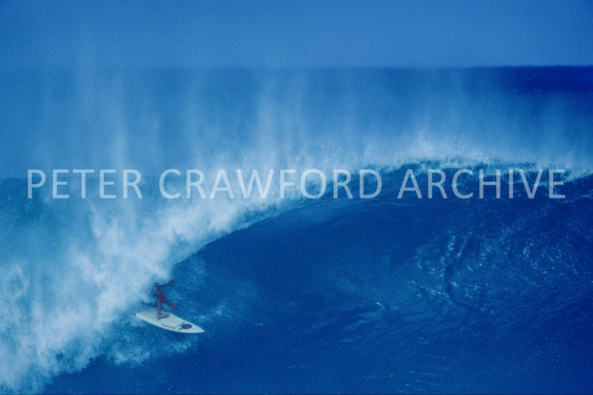 Derek Ho surfing at Pipeline during the Pipe Masters era, photographed by Peter Crawford.