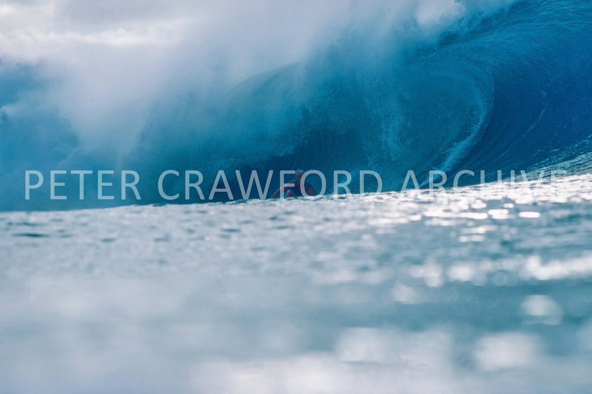 Joey Buran surfing at the 1984 Pipe Masters at Pipeline in Hawaii, photographed by Peter Crawford.