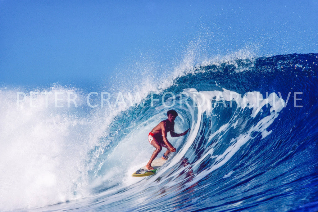 Marvin Foster surfing Pipeline in Hawaii in 1987, photographed by Peter Crawford.