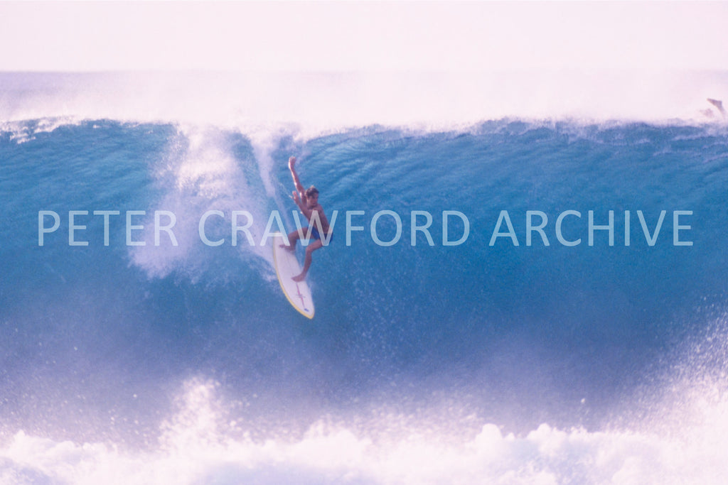 Buzzy surfing without a leash in 1975, photographed by Peter Crawford.