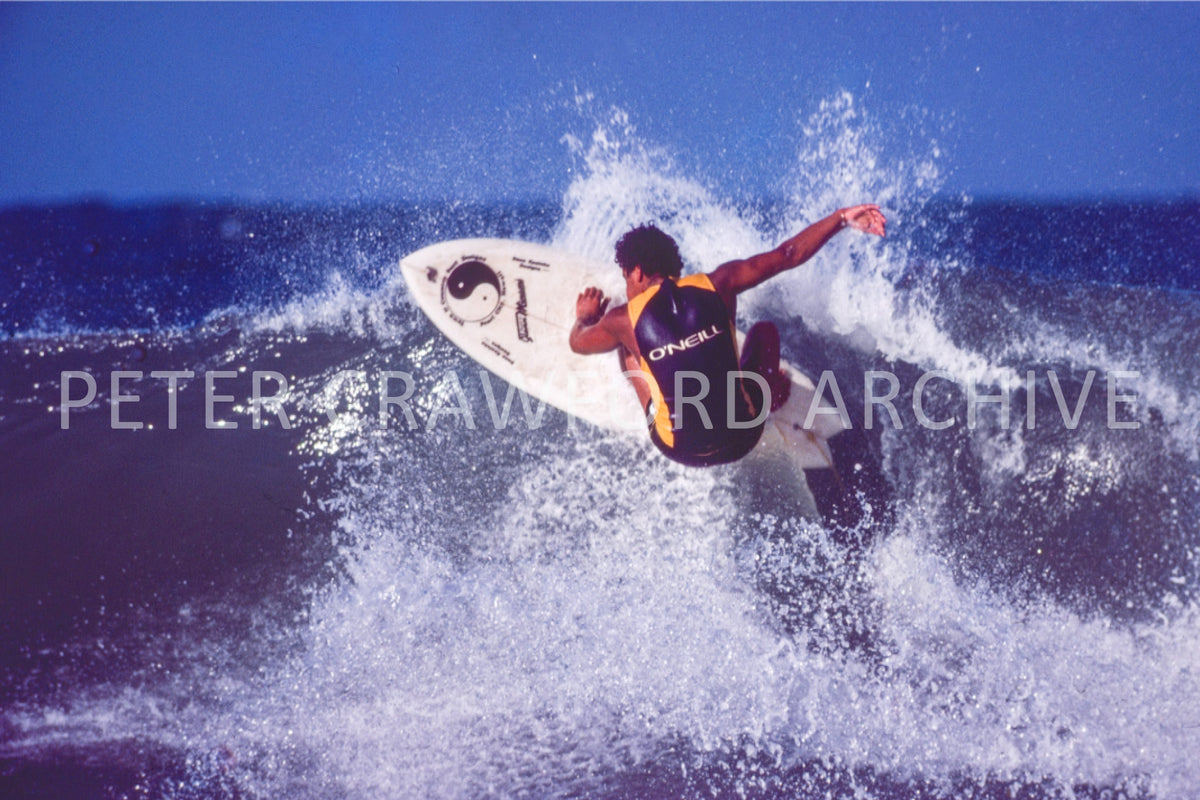 Dane Kealoha surfing Off The Wall in Hawaii in 1977, photographed by Peter Crawford.