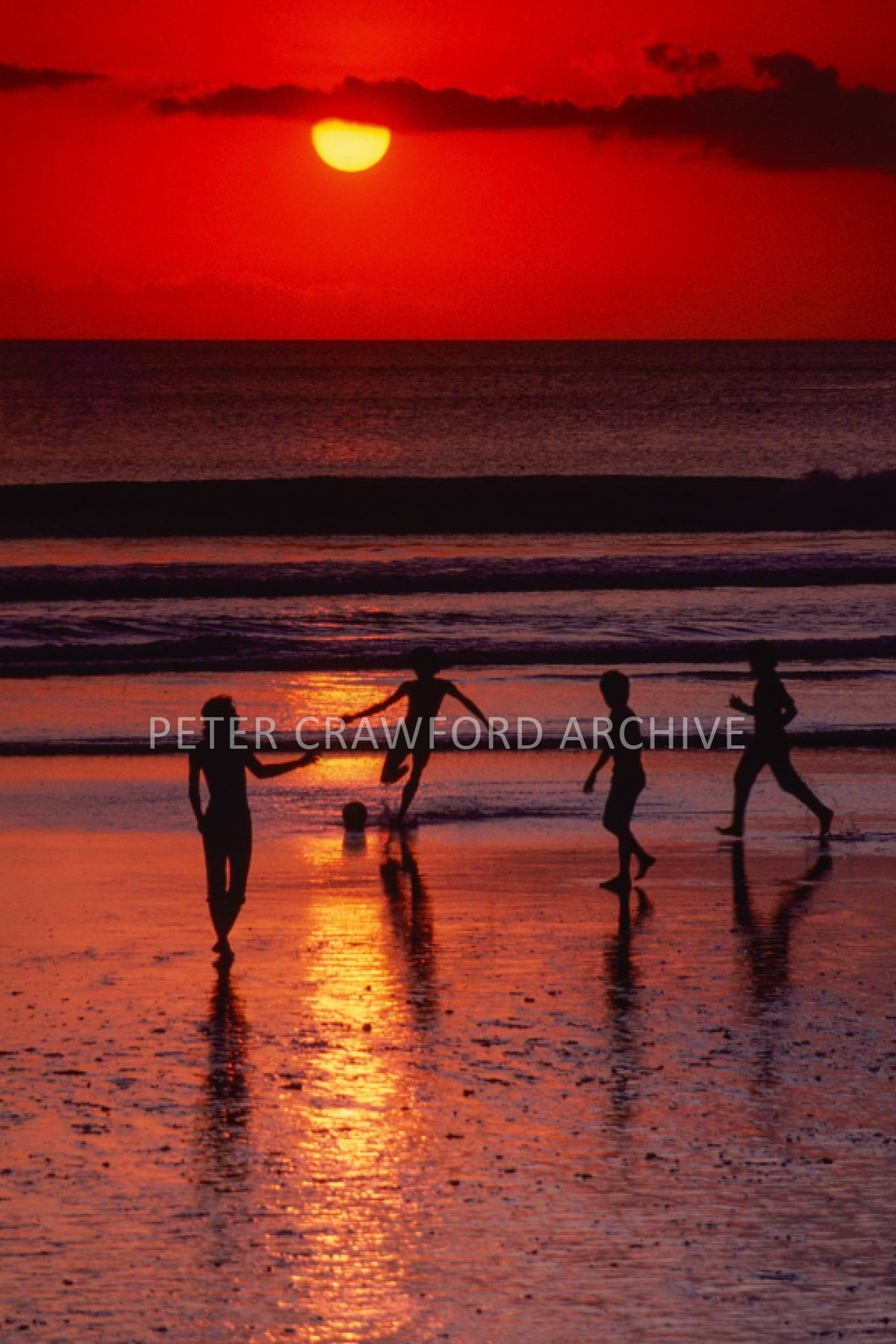 Children at sunset in Indonesia, photographed by Peter Crawford.