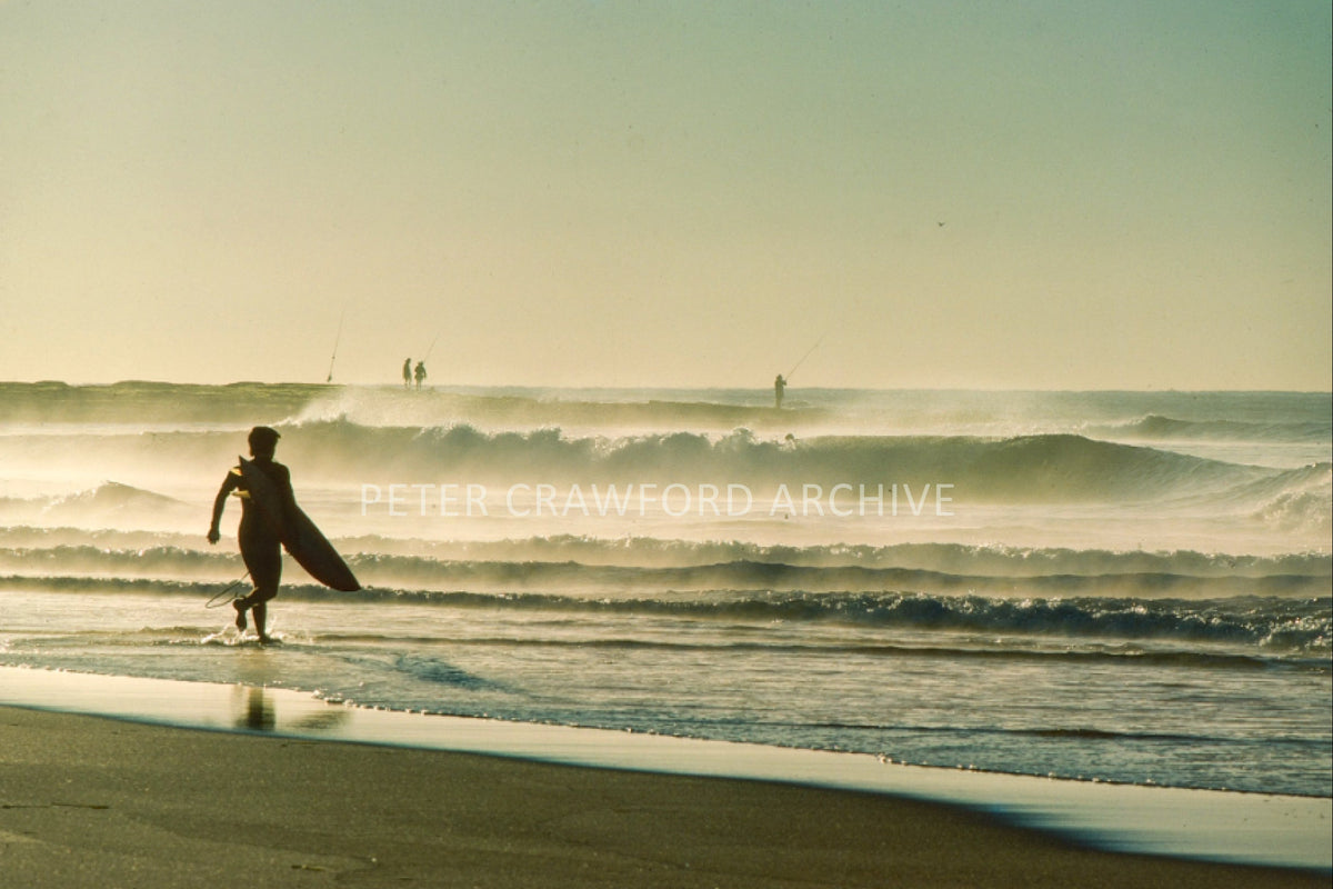 Narrabeen surfer with a fish board at dawn in 1991, photographed by Peter Crawford.