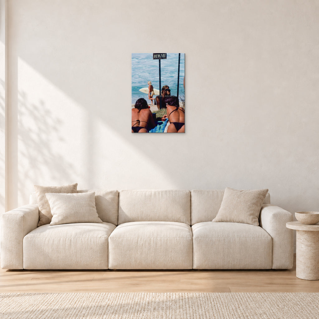 Beware Girls, 1985 by Peter Crawford — 40 × 60 cm aluminium-mounted resin print, frameless in a light minimalist living room.