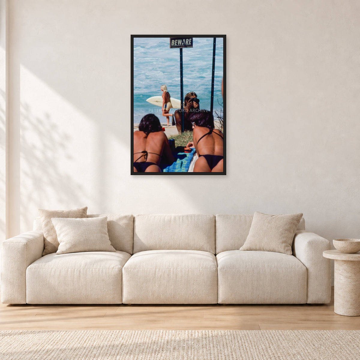Beware Girls, 1985 by Peter Crawford — 60 × 90 cm, black frame, shown in a light minimalist living room.