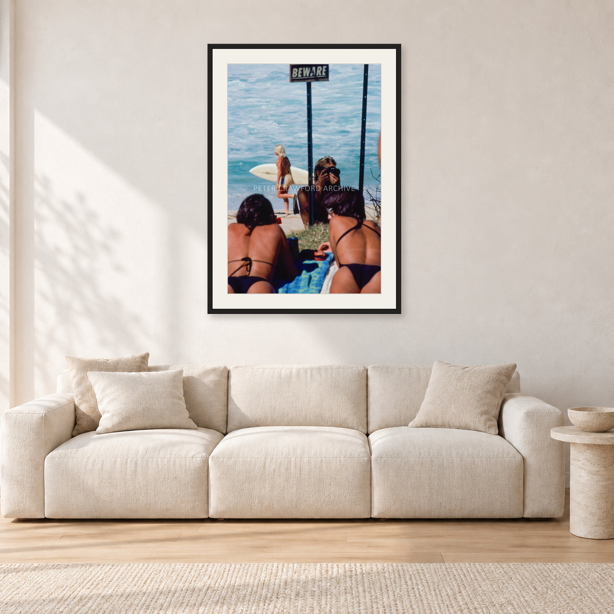 Beware Girls, 1985 by Peter Crawford — 60 × 90 cm, black frame with white mat, shown in a light minimalist living room.