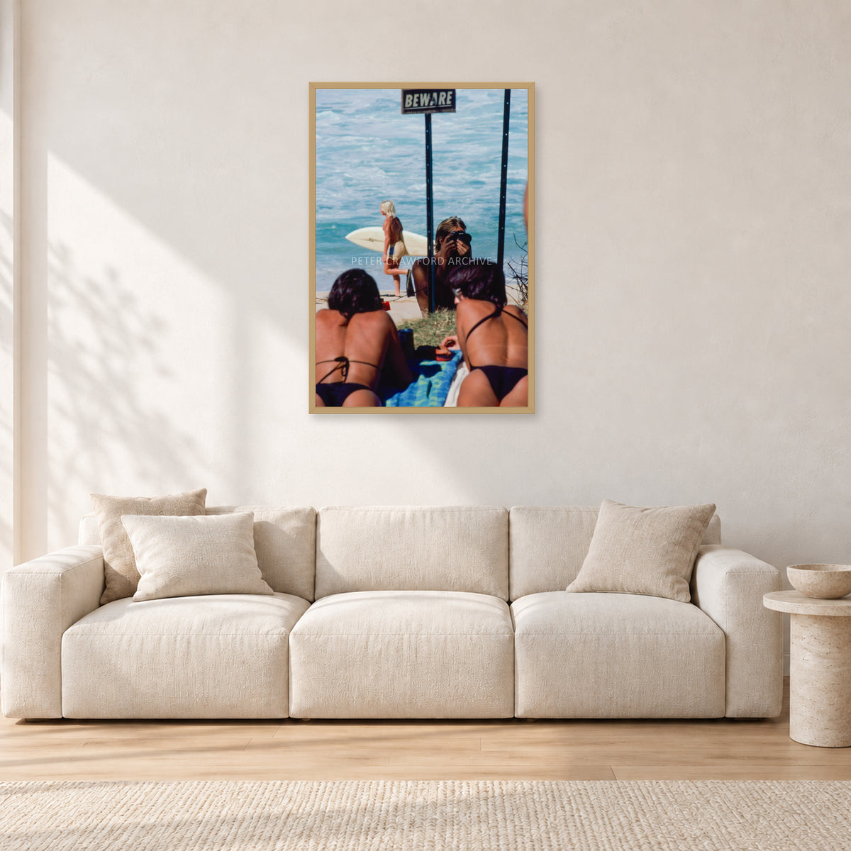 Beware Girls, 1985 by Peter Crawford — 60 × 90 cm, hayseed frame, shown in a light minimalist living room.