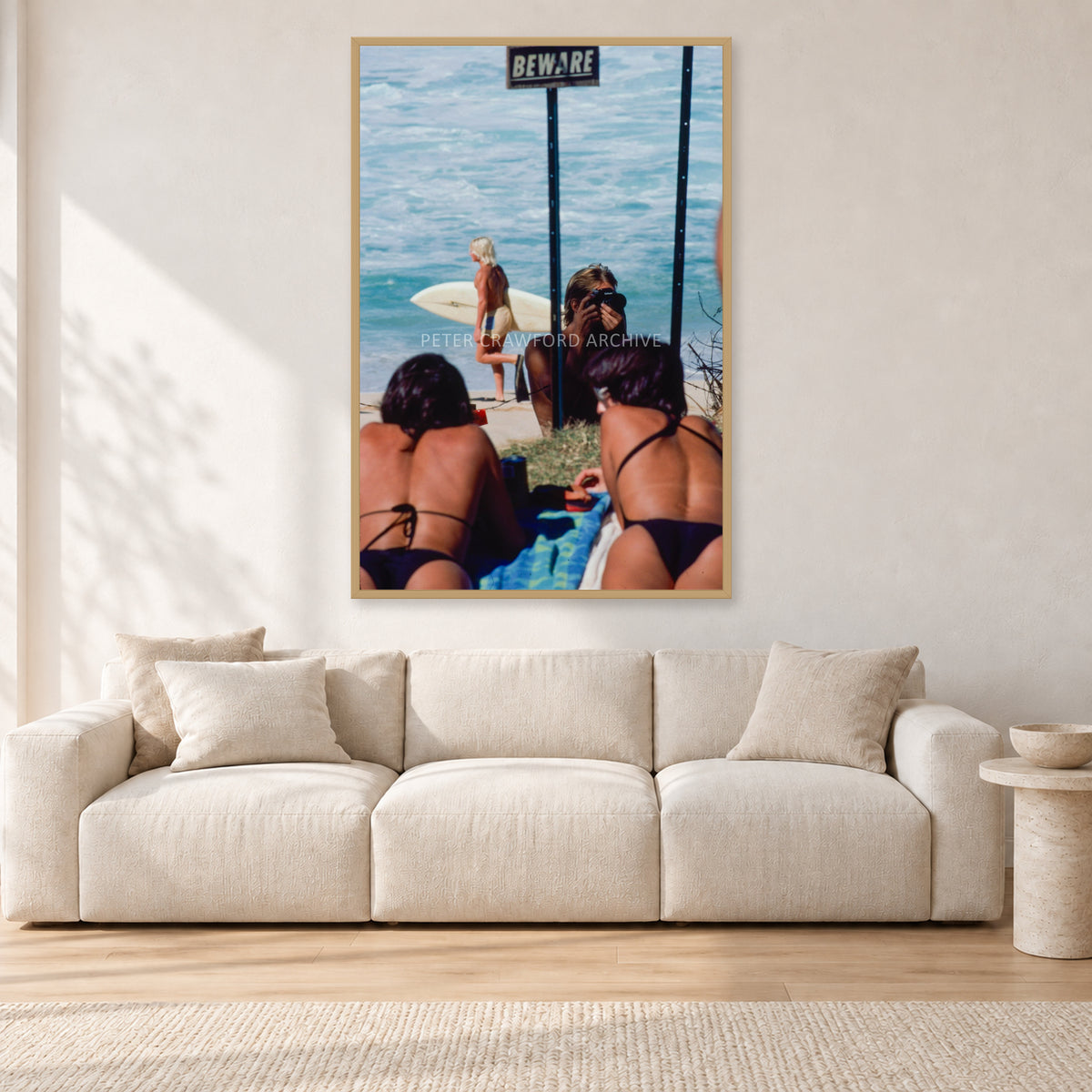 Beware Girls, 1985 by Peter Crawford — 80 × 120 cm, hayseed frame, shown in a light minimalist living room.