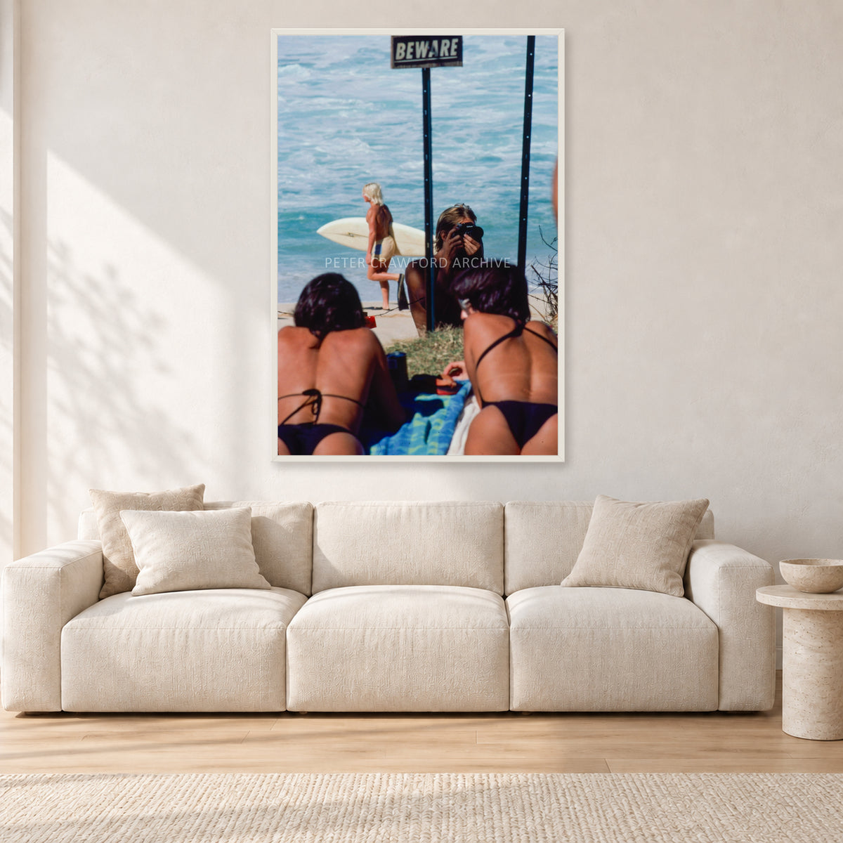 Beware Girls, 1985 by Peter Crawford — 80 × 120 cm, white frame, shown in a light minimalist living room.