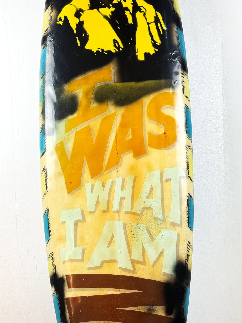 What I am Now Surfboard by David Bromley — central hand-painted lettering detail.