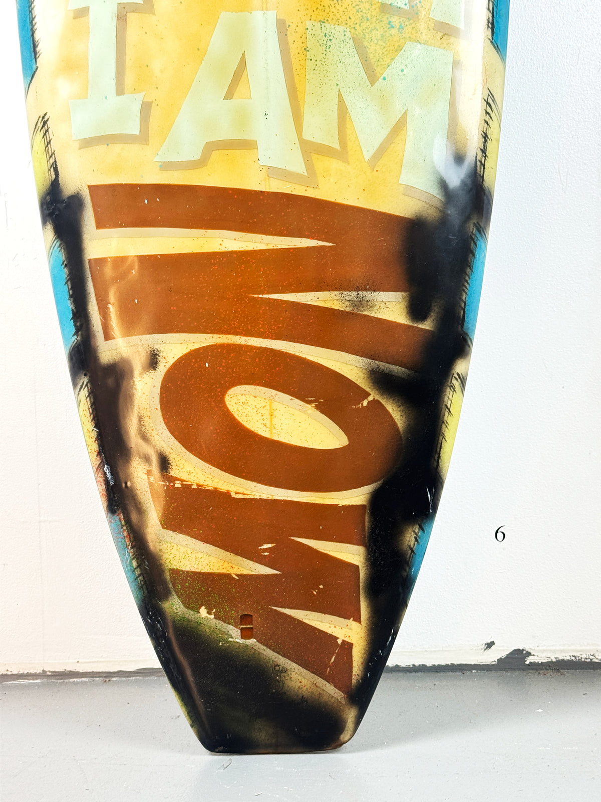 What I am Now Surfboard by David Bromley — lower brown lettering detail.
