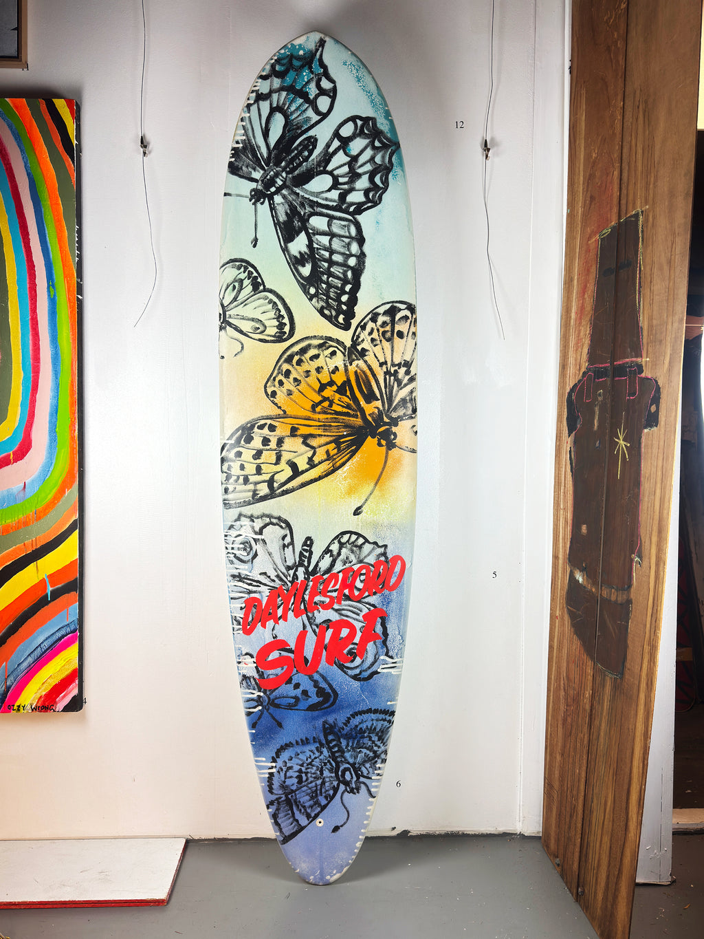 Daylesford Surf Surfboard by David Bromley — butterfly side standing in the gallery.