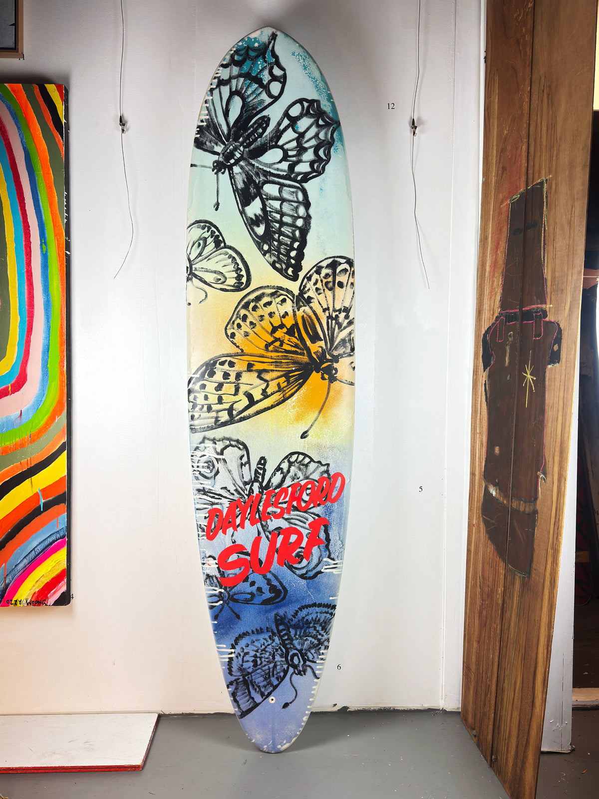 Daylesford Surf Surfboard by David Bromley — butterfly side standing in the gallery.