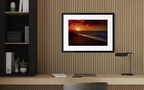 Sunset Favourite in a black frame with a white mat above a desk. Peter Crawford Archive.