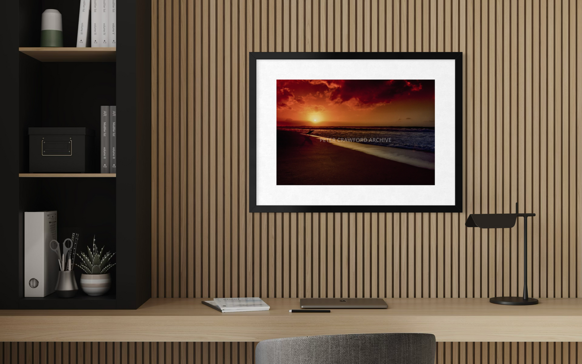 Sunset Favourite in a black frame with a white mat above a desk. Peter Crawford Archive.