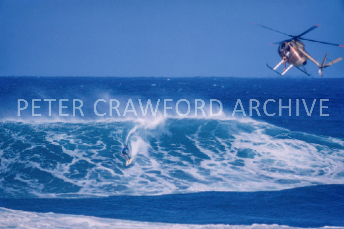 Tom Carroll surfing Sunset Beach in Hawaii, photographed from an aerial perspective by Peter Crawford.