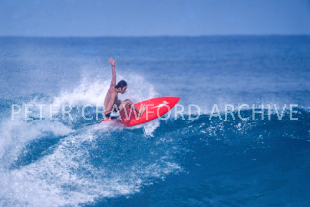 Surfer at Sunset Beach in Hawaii, photographed by Peter Crawford.