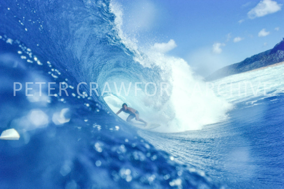 Unknown surfer at Banzai Pipeline in Hawaii in 1976, photographed by Peter Crawford.