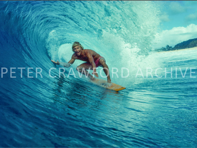 Surfer tube riding on the North Shore of Hawaii in the 1970s, photographed by Peter Crawford.
