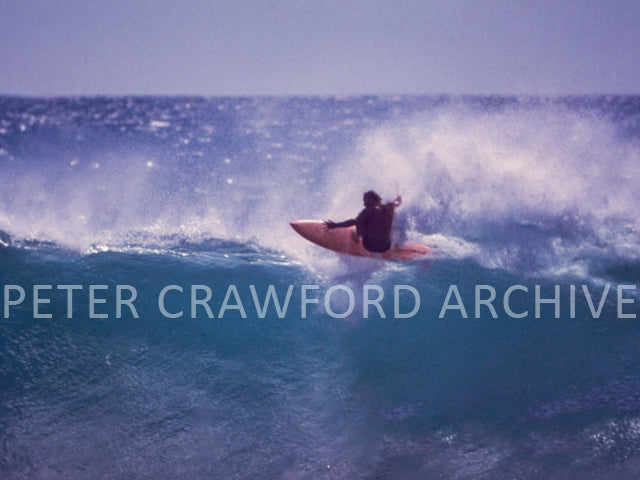Bruce Raymond surfing during the 1980 Stubbies Surf Classic at Burleigh Point, photographed by Peter Crawford.
