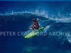 Buttons Kaluhiokalani surfing Off The Wall on the North Shore of Hawaii in 1975, photographed by Peter Crawford.