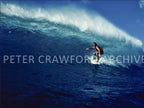 Michael Peterson surfing Sunset Beach on the North Shore of Hawaii in 1975, photographed from the water by Peter Crawford.