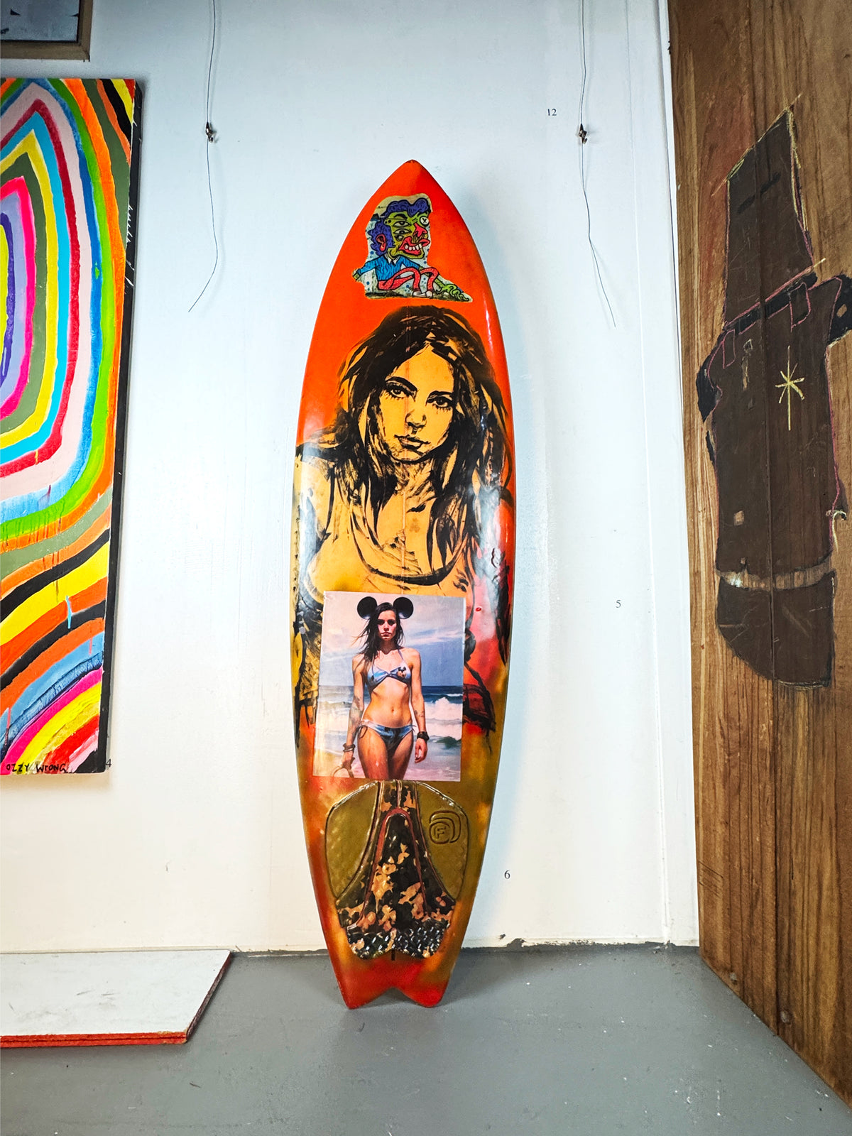 Danger Surfboard by David Bromley — orange portrait side standing in the gallery.