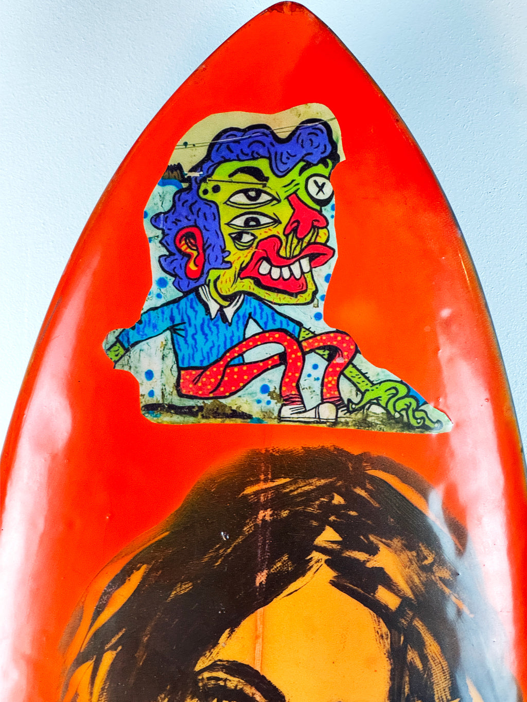 Danger Surfboard by David Bromley — orange nose and illustrated face detail.