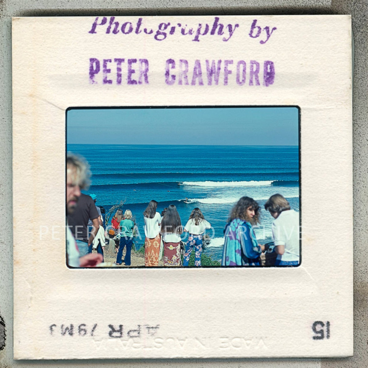 Slide with people at the beach and 'Photography by Peter Crawford' text
