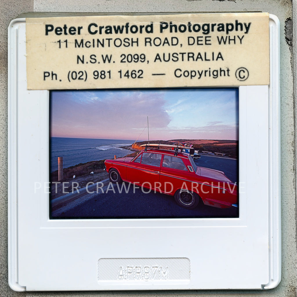 A surfer sleeps behind the wheel of a Cortina during a dawn patrol at Bells Beach in 1987. Peter Crawford Archive.