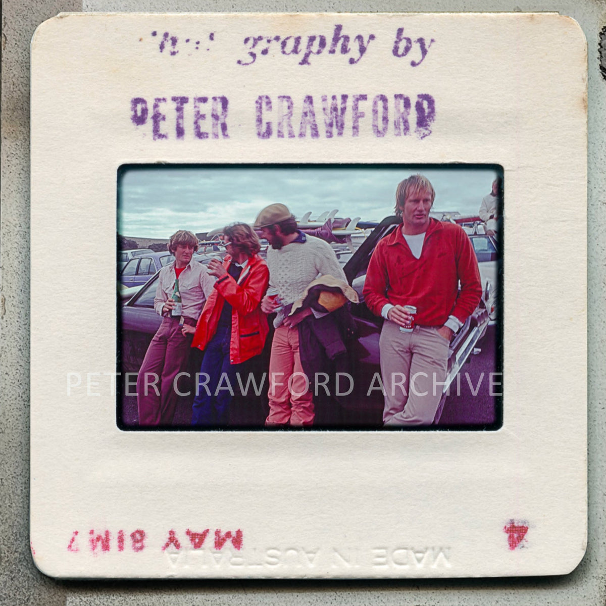 Slide with a photograph of four people on a beach, labeled 'The Photography by Peter Crawford'.