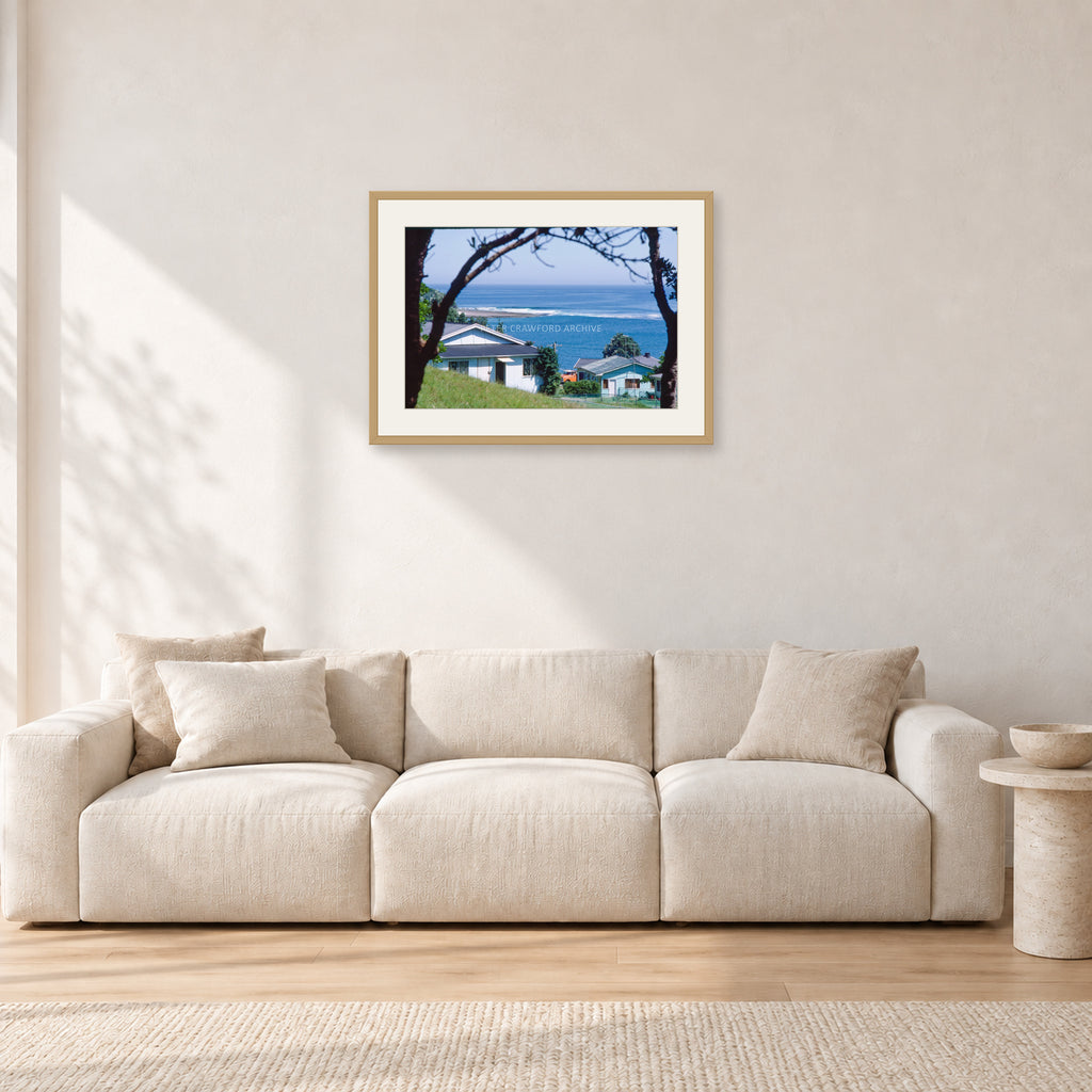 Aussie Pipe by Peter Crawford — 60 × 40 cm, hayseed frame with white mat, shown in a light minimalist living room.