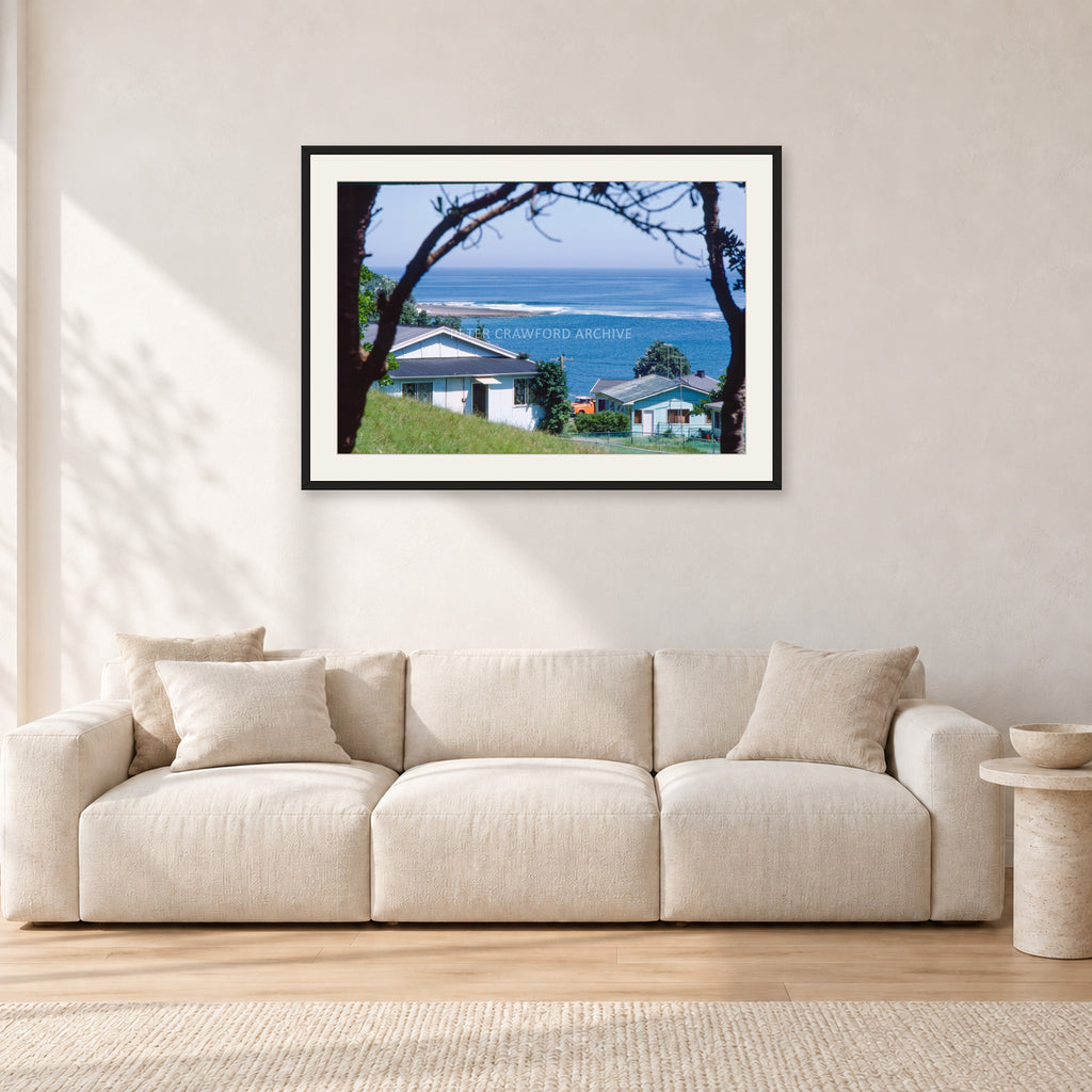 Aussie Pipe by Peter Crawford — 90 × 60 cm, black frame with white mat, shown in a light minimalist living room.