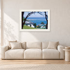 Aussie Pipe by Peter Crawford — 90 × 60 cm, white frame with white mat, shown in a light minimalist living room.