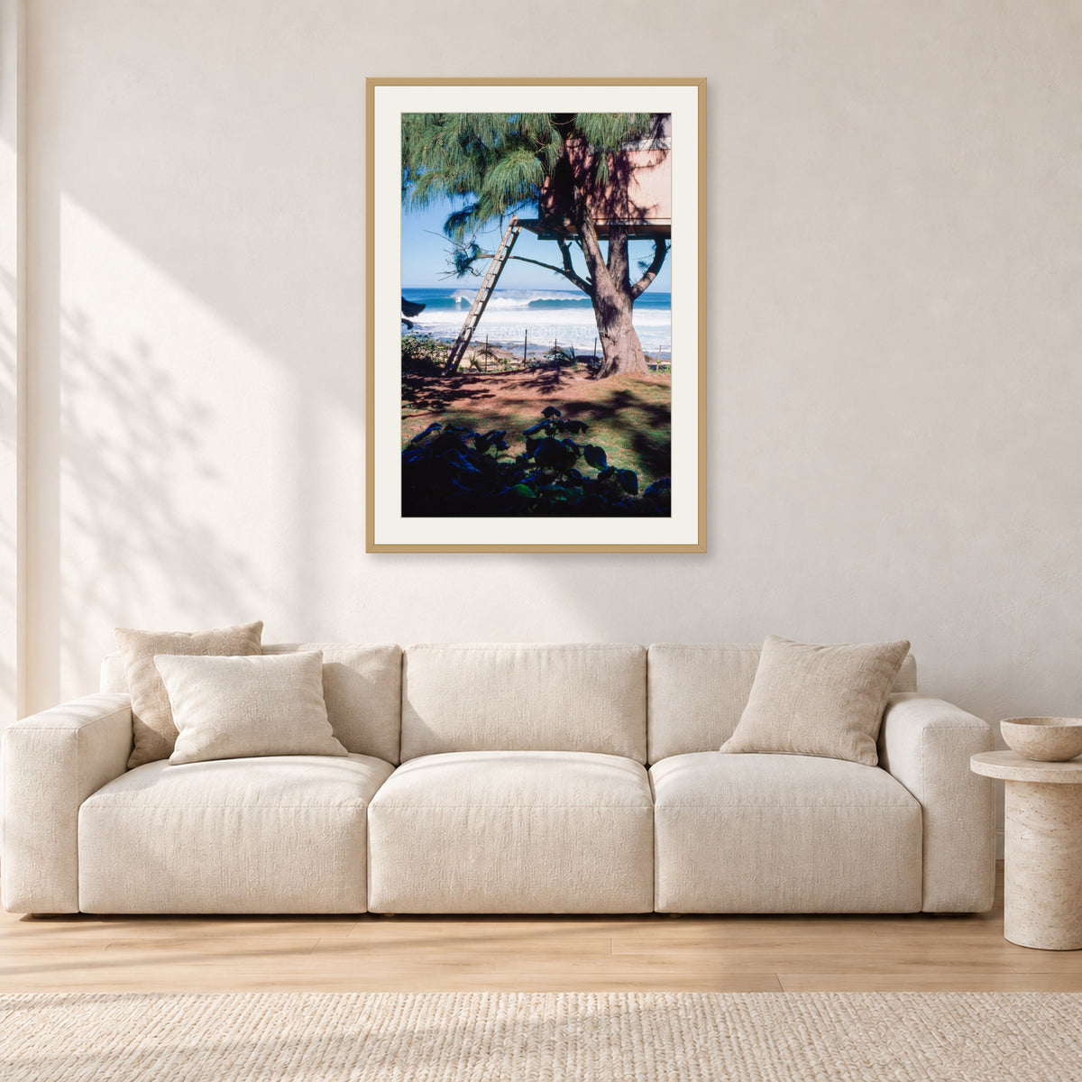 Backdoor Pipeline Tree House by Peter Crawford — 60 × 90 cm, hayseed frame with white mat, shown in a light minimalist living room.