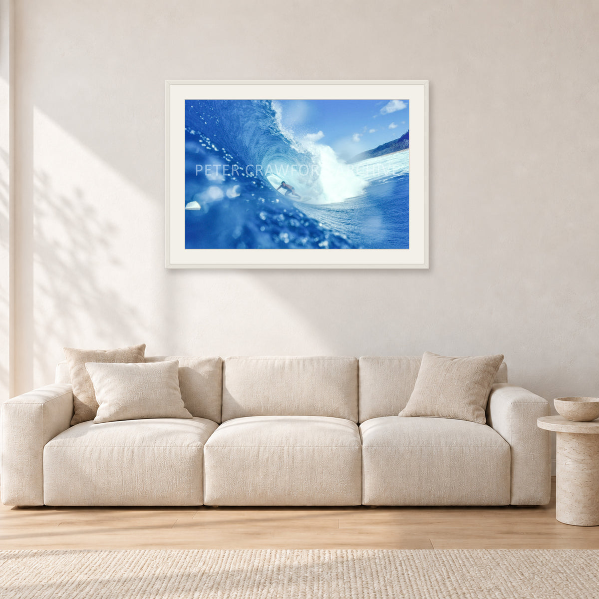 Banzai Pipeline, Hawaii 1976 by Peter Crawford — 90 × 60 cm, white frame with white mat, shown in a light minimalist living room.