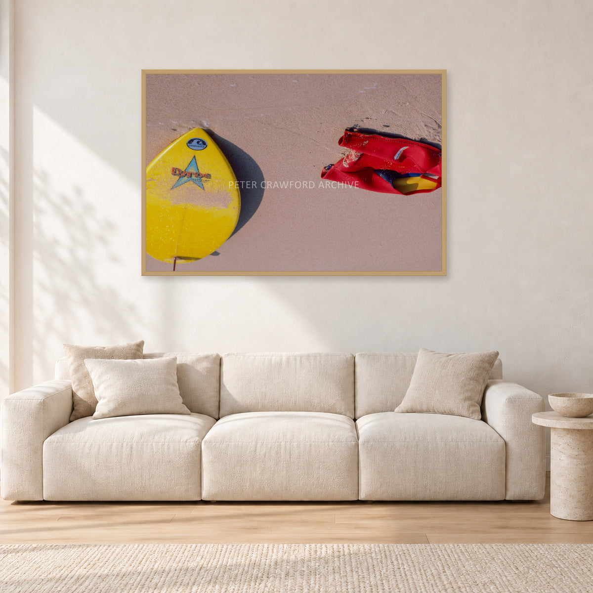 Bells Beach Overview, 1983 by Peter Crawford — 120 × 80 cm, hayseed frame, shown in a light minimalist living room.