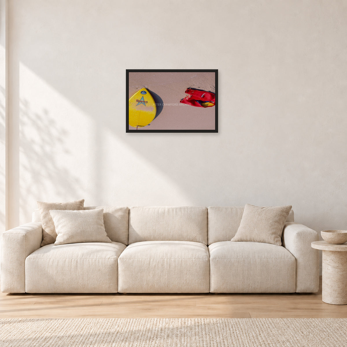 Bells Beach Overview, 1983 by Peter Crawford — 60 × 40 cm, black frame, shown in a light minimalist living room.