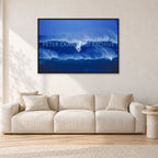Big Sunset, Unknown Surfer by Peter Crawford — 120 × 80 cm, black frame, shown in a light minimalist living room.