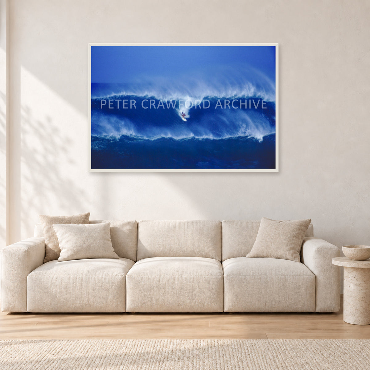 Big Sunset, Unknown Surfer by Peter Crawford — 120 × 80 cm, white frame, shown in a light minimalist living room.