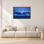 Big Sunset, Unknown Surfer by Peter Crawford — 90 × 60 cm, black frame, shown in a light minimalist living room.