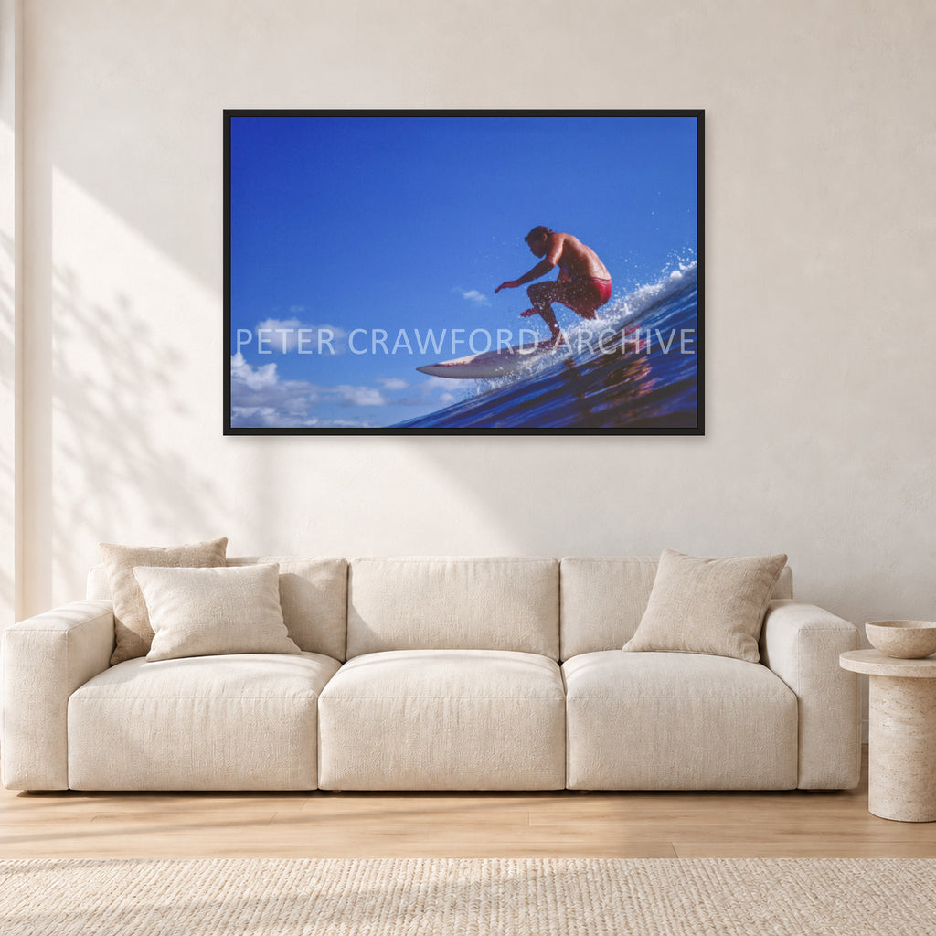 Bruce Raymond, 1976 by Peter Crawford — 120 × 80 cm, black frame, shown in a light minimalist living room.