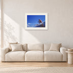 Bruce Raymond, 1976 by Peter Crawford — 60 × 40 cm, white frame with white mat, shown in a light minimalist living room.
