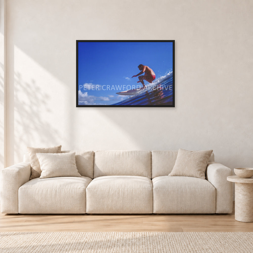 Bruce Raymond, 1976 by Peter Crawford — 90 × 60 cm, black frame, shown in a light minimalist living room.