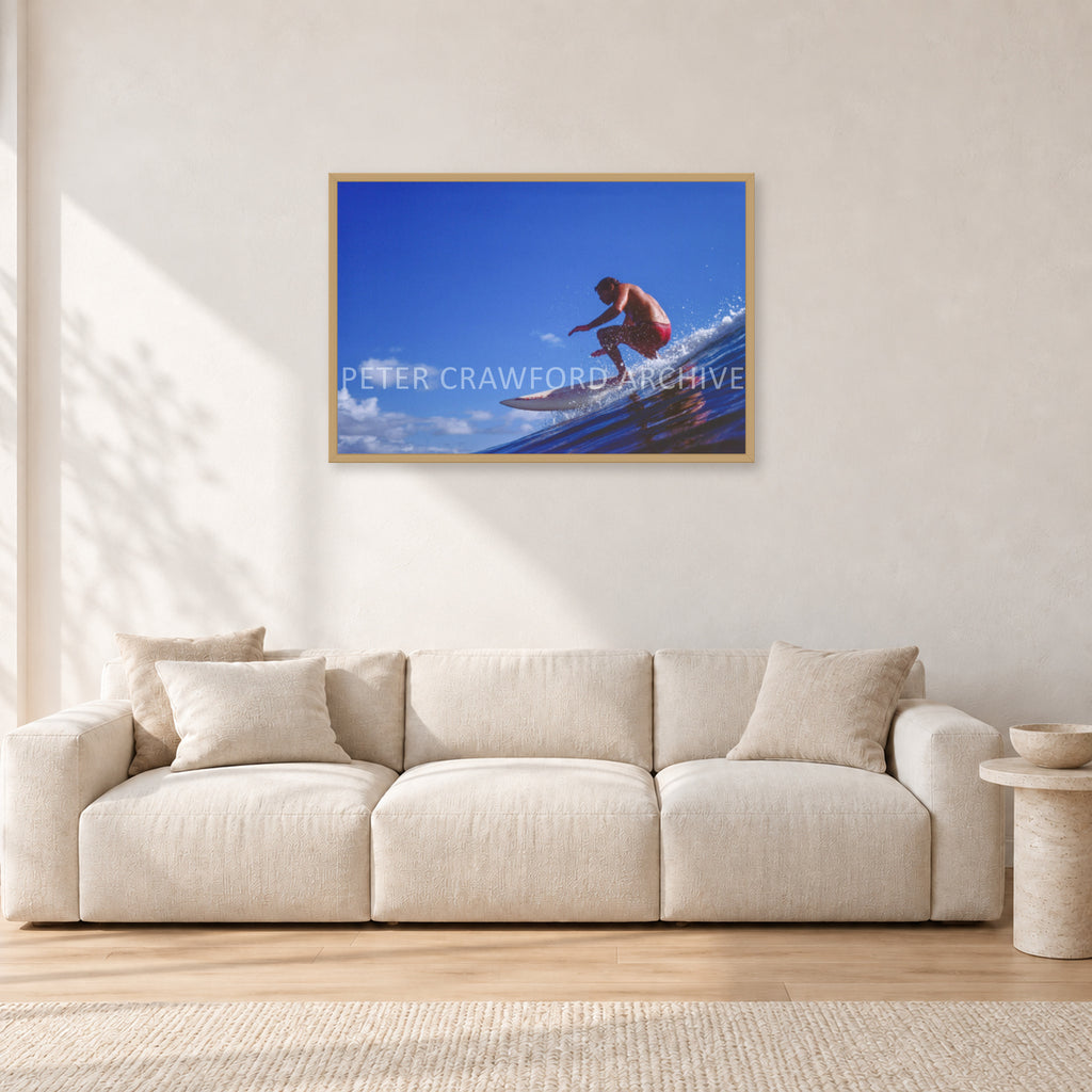 Bruce Raymond, 1976 by Peter Crawford — 90 × 60 cm, hayseed frame, shown in a light minimalist living room.