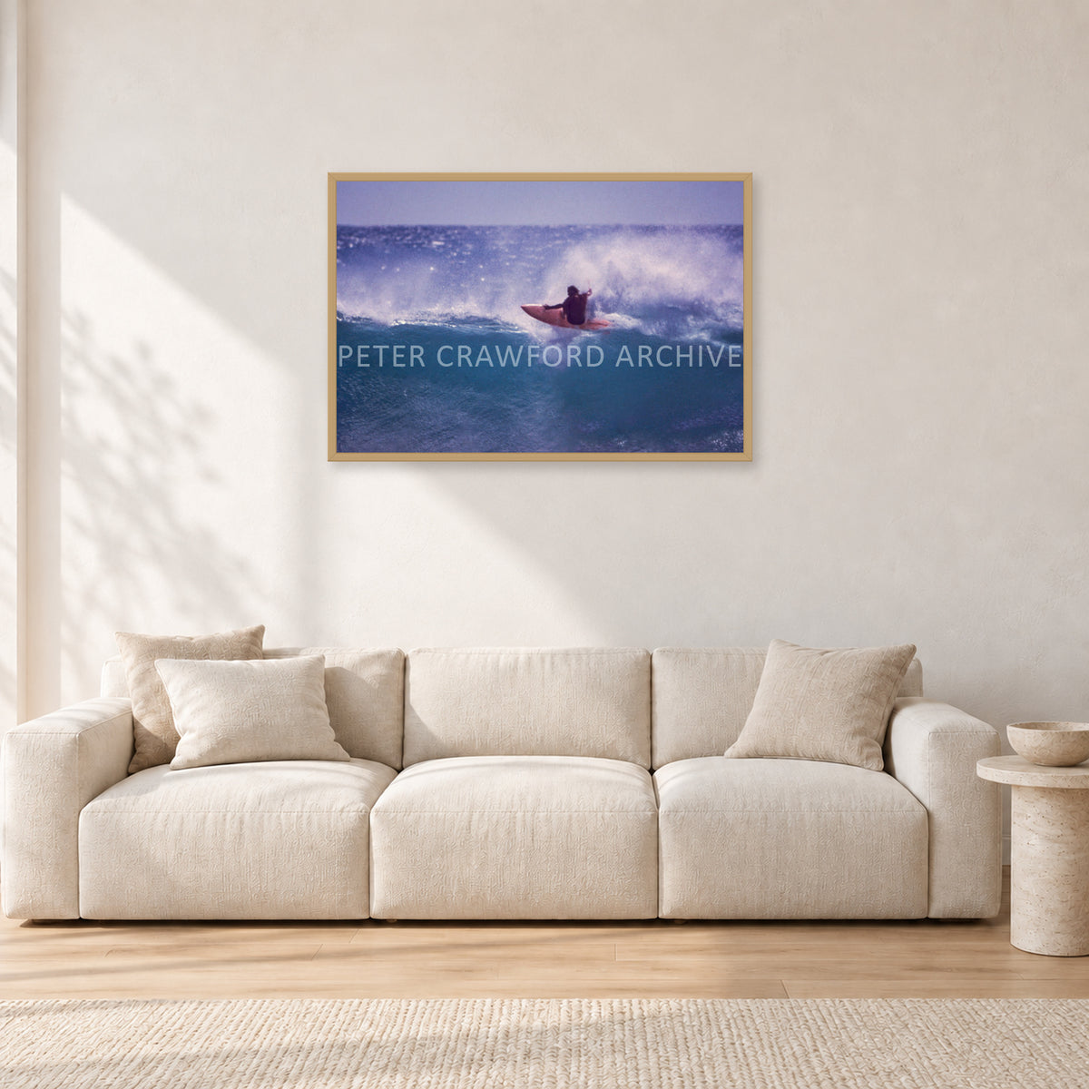 Bruce Raymond, Stubbies 1980 by Peter Crawford — 90 × 60 cm, hayseed frame, shown in a light minimalist living room.