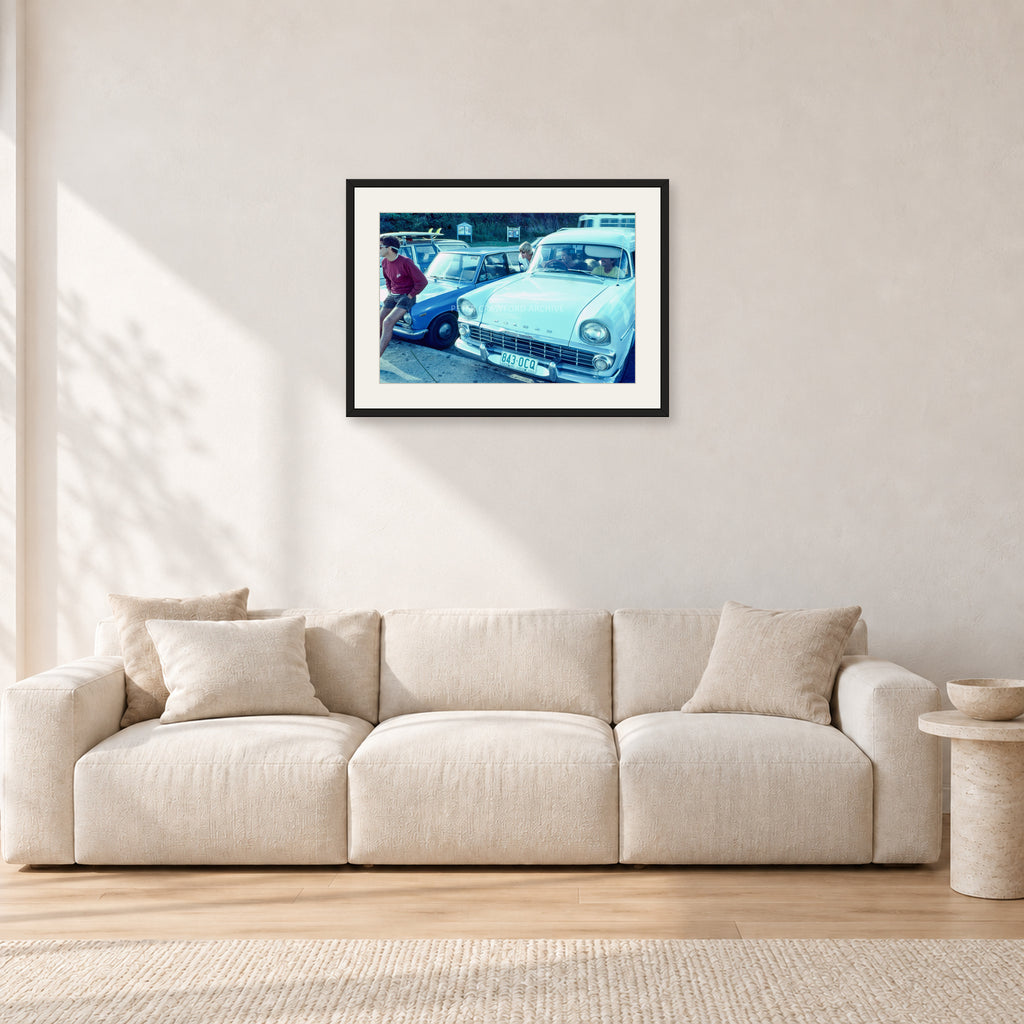 Bugs, Rainbow Bay 1976 by Peter Crawford — 60 × 40 cm, black frame with white mat, shown in a light minimalist living room.
