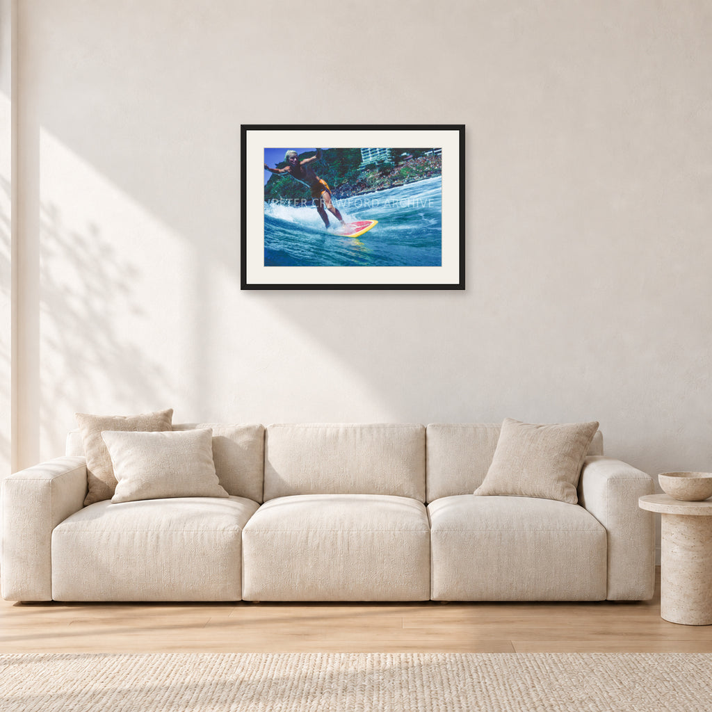 Cheyne Horan, Stubbies 1978 by Peter Crawford — 60 × 40 cm, black frame with white mat, shown in a light minimalist living room.