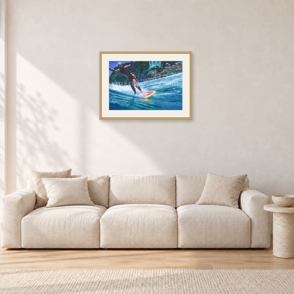 Cheyne Horan, Stubbies 1978 by Peter Crawford — 60 × 40 cm, hayseed frame with white mat, shown in a light minimalist living room.